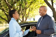 Father and son near the vehicle