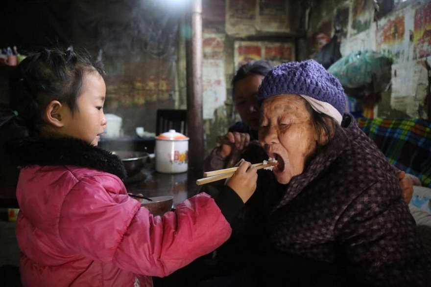 Chinese grandchild taking care of her grandmother