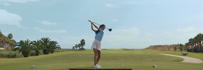 Young female hitting a golf ball