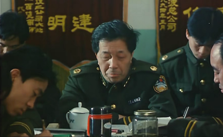 Yang sits next to the commissioner at the beginning