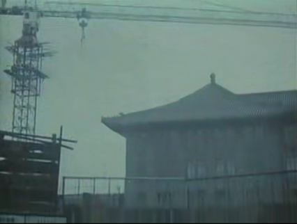 The crane is demolishing the traditional buildings 